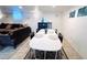 Living space featuring couches, a white dining table, black chairs and natural light at 413 Jamaica St, Aurora, CO 80010