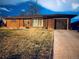 Well-kept single-story brick home with attached garage and manicured front lawn at 413 Jamaica St, Aurora, CO 80010