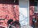 Exterior view of the home's back door, with a bicycle parked beside the brick wall at 413 Jamaica St, Aurora, CO 80010