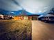 Charming single-story brick home with a well-maintained lawn and a paved driveway at 413 Jamaica St, Aurora, CO 80010