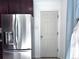 Modern stainless steel refrigerator, alongside dark wood cabinets and a white pantry door at 413 Jamaica St, Aurora, CO 80010