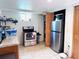 Efficient kitchen with stainless steel appliances, open shelving, and wood accents at 413 Jamaica St, Aurora, CO 80010