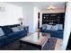 Comfortable living room featuring two sofas, a stylish coffee table, and hardwood floors at 413 Jamaica St, Aurora, CO 80010