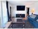 Living room featuring hardwood floors, a television, two sofas and large, bright windows at 413 Jamaica St, Aurora, CO 80010