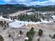 Areal view of open land, trees, and a frozen pond at 9299 William Cody Dr, Evergreen, CO 80439