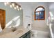 Bright bathroom featuring a marble countertop, elegant lighting, and a large window at 9299 William Cody Dr, Evergreen, CO 80439