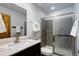 Bathroom featuring a glass shower enclosure, neutral tile, and vanity with marble top at 9299 William Cody Dr, Evergreen, CO 80439