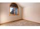 A cozy bedroom with neutral walls, carpet, and a large window offering natural light at 9299 William Cody Dr, Evergreen, CO 80439