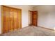 A bedroom with a closet and a neutral color palette that creates a calm and peaceful atmosphere at 9299 William Cody Dr, Evergreen, CO 80439