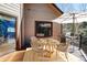 This outdoor deck is furnished with a dining table and chairs, as well as a grill for outdoor cooking at 9299 William Cody Dr, Evergreen, CO 80439