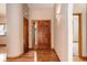 Spacious foyer features hardwood floors, warm wall color, and stylish sconces at 9299 William Cody Dr, Evergreen, CO 80439