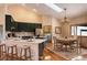Eat-in kitchen featuring quartz countertops, stainless appliances, and modern lighting at 9299 William Cody Dr, Evergreen, CO 80439