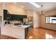 Eat-in kitchen featuring quartz countertops, stainless appliances, and modern lighting at 9299 William Cody Dr, Evergreen, CO 80439