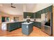 Spacious kitchen with center island, stainless steel appliances, and hardwood floors at 9299 William Cody Dr, Evergreen, CO 80439