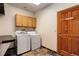 Functional laundry room with side-by-side washer and dryer, plus storage space at 9299 William Cody Dr, Evergreen, CO 80439