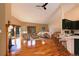 Living room features a fireplace, wood floors, lots of natural light and an open connection to the kitchen at 9299 William Cody Dr, Evergreen, CO 80439