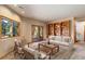An elegantly staged living room featuring a built-in bookcase and direct access to the outdoors at 9299 William Cody Dr, Evergreen, CO 80439