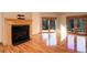 Living room featuring a fireplace, hardwood floors, and sliding glass doors to a deck at 9299 William Cody Dr, Evergreen, CO 80439