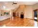 Spacious living room with vaulted ceilings, hardwood floors, and a cozy fireplace at 9299 William Cody Dr, Evergreen, CO 80439
