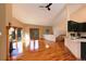 Bright living room with fireplace, hardwood floors, and access to the outside at 9299 William Cody Dr, Evergreen, CO 80439