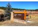 Entrance sign for Flying J Ranch Park in a beautiful mountain setting at 9299 William Cody Dr, Evergreen, CO 80439