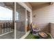 A cozy balcony space with a swivel chair, ottoman, and sliding glass doors leading to indoor living at 9318 Las Ramblas Ct # R, Parker, CO 80134