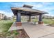 Outdoor community space with gazebo seating amid manicured lawns and well-maintained residential buildings at 9318 Las Ramblas Ct # R, Parker, CO 80134