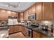 Well-lit kitchen with stainless steel appliances, tile backsplash, and granite countertops at 9318 Las Ramblas Ct # R, Parker, CO 80134