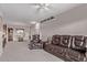 Spacious living area with comfortable leather seating, a dining area, and light gray walls for a cozy atmosphere at 9318 Las Ramblas Ct # R, Parker, CO 80134