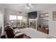 Inviting living room with fireplace, balcony access and mounted TV at 9318 Las Ramblas Ct # R, Parker, CO 80134