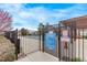 An outdoor pool with fence. Sign indicates that there is no lifeguard on duty at 9318 Las Ramblas Ct # R, Parker, CO 80134