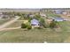 Aerial view of a home and grounds, surrounded by green fields and mature trees in a rural setting at 15020 Harrison St, Brighton, CO 80602