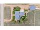 Aerial view of a sprawling property with a home, garage, landscaped grounds, and a circular driveway at 15020 Harrison St, Brighton, CO 80602