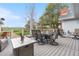 Spacious back deck with a large dining table, comfortable seating, and open backyard views at 15020 Harrison St, Brighton, CO 80602