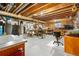 Basement featuring a large workshop area with wooden beams, pegboard, and great light at 15020 Harrison St, Brighton, CO 80602