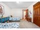 Bright bedroom featuring twin beds and attached bathroom at 15020 Harrison St, Brighton, CO 80602