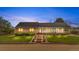 Beautiful home exterior featuring a covered porch, landscaped yard, and brick accents at 15020 Harrison St, Brighton, CO 80602