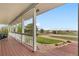 Inviting covered front porch, features wooden floors, columns, railing and stunning views at 15020 Harrison St, Brighton, CO 80602