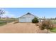 Image of a single-story outbuilding or garage with sliding doors and gravel driveway at 15020 Harrison St, Brighton, CO 80602