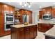 Gourmet kitchen featuring custom wood cabinets, stainless steel appliances, and a granite island at 15020 Harrison St, Brighton, CO 80602