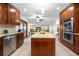 Spacious kitchen featuring wood cabinets, stainless steel appliances, and an island at 15020 Harrison St, Brighton, CO 80602