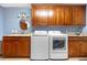 Laundry room with modern appliances and beautiful cabinets at 15020 Harrison St, Brighton, CO 80602