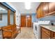 Functional laundry room with washer, dryer, and cabinet storage at 15020 Harrison St, Brighton, CO 80602