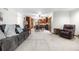 Open-concept living area featuring a comfortable sofa, kitchen, dining space, and ample natural light at 15020 Harrison St, Brighton, CO 80602