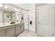 Contemporary bathroom with a double vanity, sleek mirrors, and a glass-enclosed shower with white tiles at 3418 Belleville Ridge Rd, Elizabeth, CO 80107