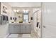 Bathroom featuring a double vanity, white countertops, modern lighting, and a glass-enclosed shower at 3418 Belleville Ridge Rd, Elizabeth, CO 80107