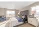 Bedroom showcasing a tufted headboard, large windows, plush carpeting, and a side table with decor at 3418 Belleville Ridge Rd, Elizabeth, CO 80107
