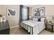 Cozy bedroom showcasing a stylish bed with blue accents, framed artwork, and a window with natural light at 3418 Belleville Ridge Rd, Elizabeth, CO 80107