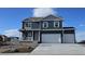 Charming two-story home featuring a three-car garage, landscaped yard, and a welcoming front porch at 3418 Belleville Ridge Rd, Elizabeth, CO 80107