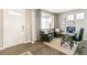 Well lit office and study features dark wood flooring, large windows, modern desk and comfortable seating at 3418 Belleville Ridge Rd, Elizabeth, CO 80107
